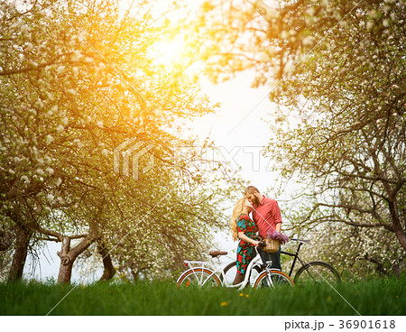 Loving young couple with bicycles in spring garden 36901618