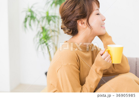 部屋で飲み物を飲む女性 36905985