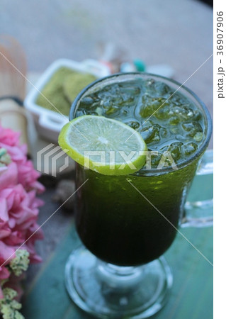 Iced green tea with lemon and matcha tea powder. 36907906