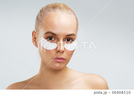 Beauty shot of a young woman with undereye mask Beauty shot of a young woman with undereye mask 36908510