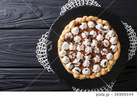 French silk pie is decorated with whipped cream 36909344