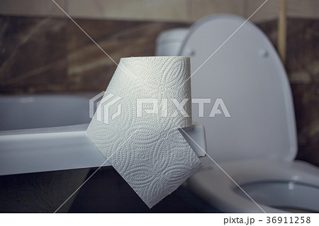 Toilet paper roll on the edge of the bath. On the 36911258