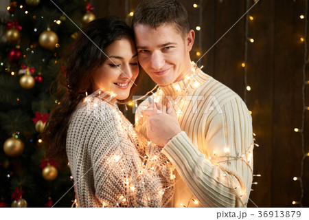 young couple together in christmas decoration young couple together in christmas decoration 36913879