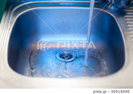 A stream of clean water flows into the stainless 36918996