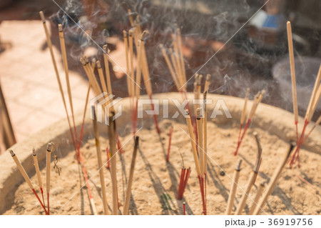 Incense sticks burning with white smoke Incense sticks burning with white smoke 36919756