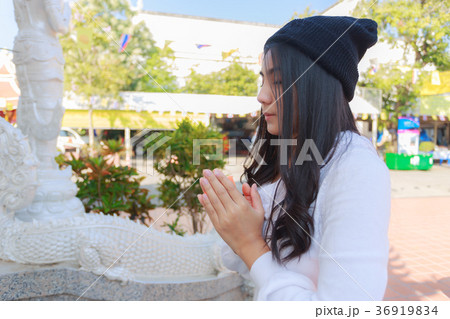 Asian woman pay homage to a Buddha image Asian woman pay homage to a Buddha image 36919834