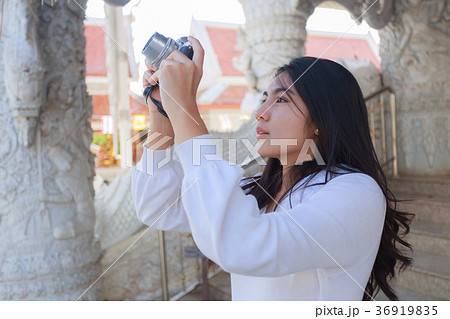 Asian woman taking photo at Buddhist Temp Asian woman taking photo at Buddhist Temp 36919835