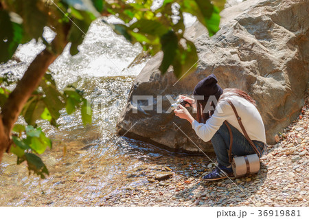 Woman hiking around mountains near the river Woman hiking around mountains near the river 36919881