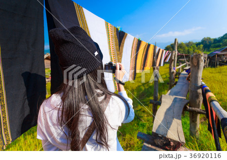 Asian woman taking photo colorful Thai sarongs 36920116