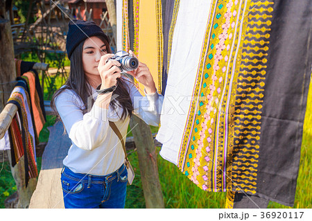 Asian woman taking photo colorful Thai sarongs Asian woman taking photo colorful Thai sarongs 36920117