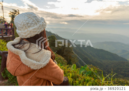 Asian woman relaxing on top of a mountain 36920121