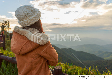 Asian woman relaxing on top of a mountain Asian woman relaxing on top of a mountain 36920122