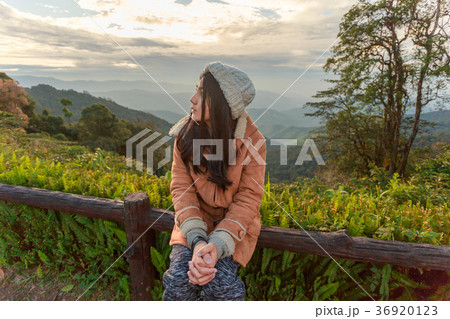 Asian woman relaxing on top of a mountain 36920123