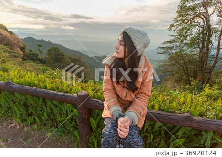 Asian woman relaxing on top of a mountain 36920124