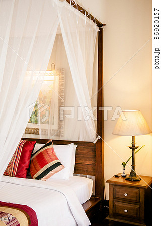 Colonial style wooden four poster bed with curtain 36920157