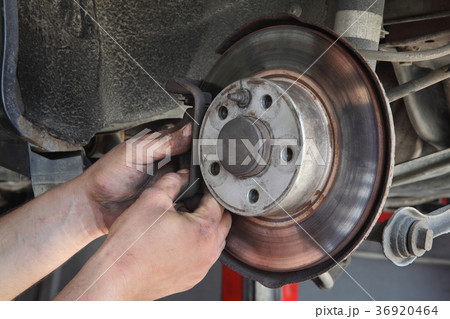 Car mechanic working on disc brakes Car mechanic working on disc brakes 36920464