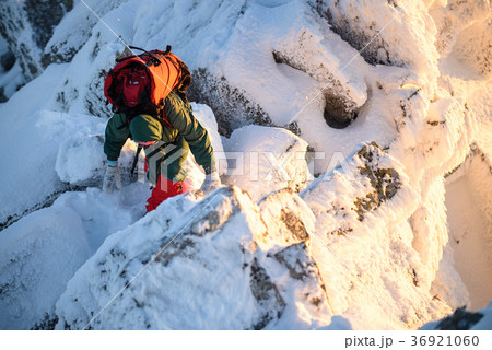 Woman hiker with backpack on the mountain top Woman hiker with backpack on the mountain top 36921060