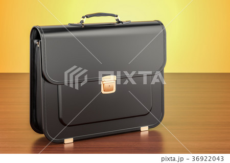Black leather briefcase on the wooden table 36922043