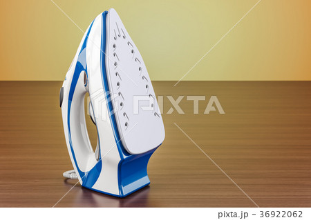 Electric steam iron on the wooden table Electric steam iron on the wooden table 36922062