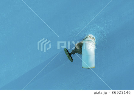 Blue water hose with water valve, blue background Blue water hose with water valve, blue background 36925146