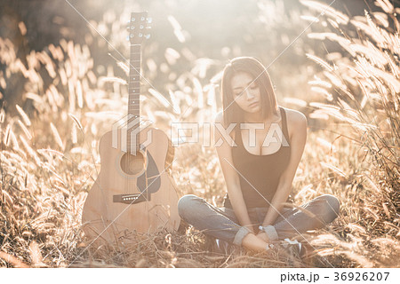 Beautiful young girl carrying her guitar Beautiful young girl carrying her guitar 36926207