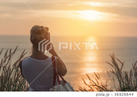 woman taking photos of sunset .Koh Phuket woman taking photos of sunset .Koh Phuket 36926644