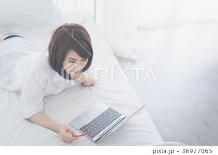 girl in glasses shopping on internet by laptop a 36927065