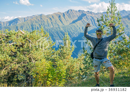hands up. One tourist in shorts and a sweatshirt 36931182