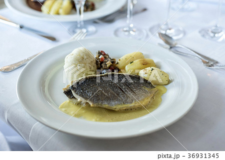 White dinner plate with fish filet steak and White dinner plate with fish filet steak and 36931345