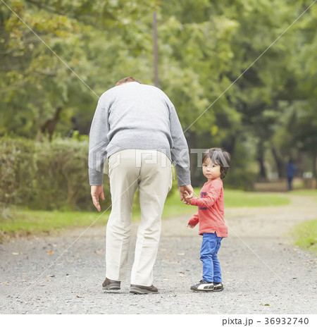 孫と遊ぶシニアの写真素材