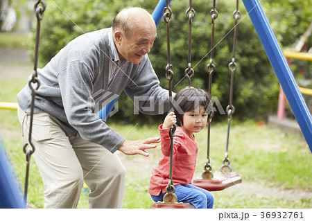 孫と遊ぶシニアの写真素材