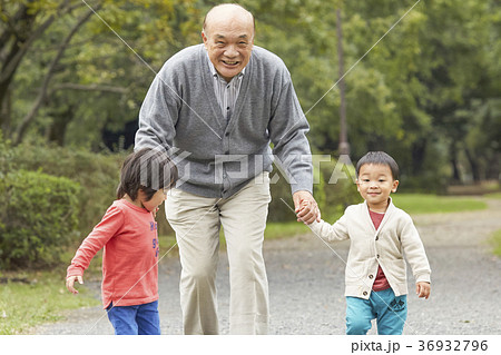 孫と遊ぶシニアの写真素材