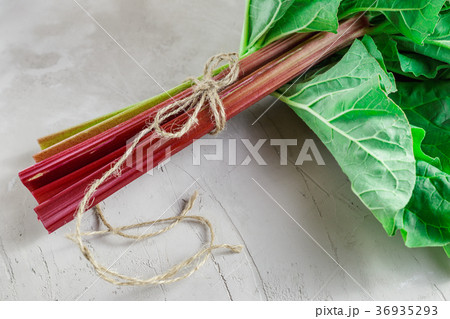 Fresh organic rhubarb on grey concrete background Fresh organic rhubarb on grey concrete background 36935293