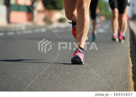 Marathon runners running on city road Marathon runners running on city road 36935837