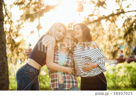 woman hugging each other in close embrace while 36937025