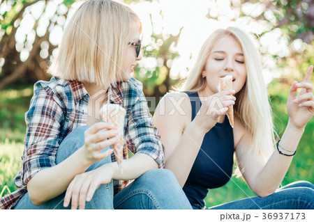 Two best friends having ice cream and laughing 36937173