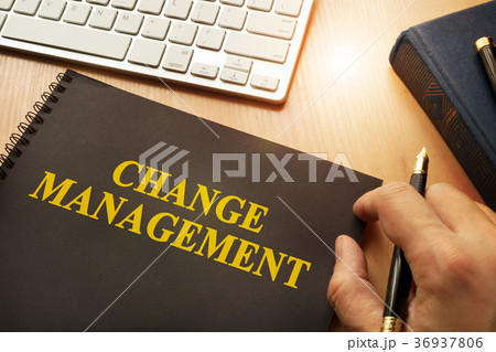 Book with change management on a table. 36937806