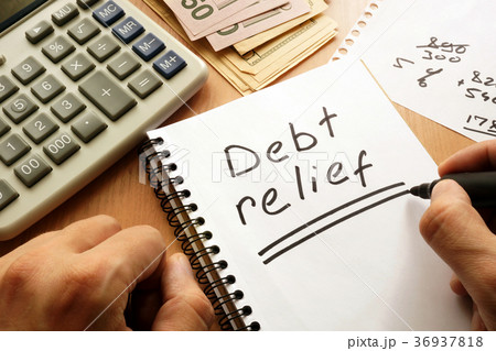 Note with words debt relief on a table. 36937818