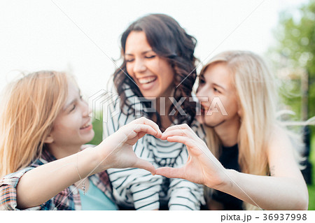 Adult sisters in a park at wonderful day making 36937998