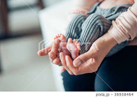 Baby's foot in mother hands 36938464