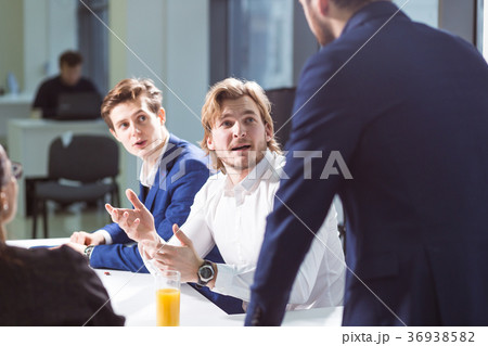 smiling male boss talking to business group smiling male boss talking to business group 36938582