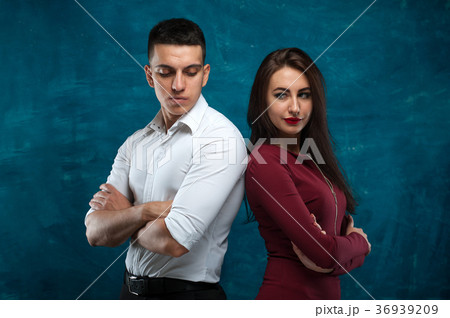 Young couple posing on blue background 36939209