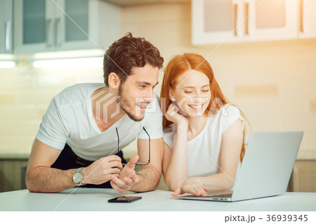 couple watching photoes from honey moon together couple watching photoes from honey moon together 36939345