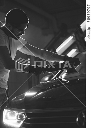 Car polish wax. worker hands holding a polisher Car polish wax. worker hands holding a polisher 36939797