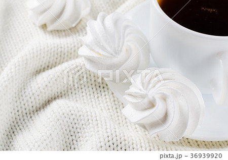 Delicious meringue cookies and cup of hot tea. Delicious meringue cookies and cup of hot tea. 36939920
