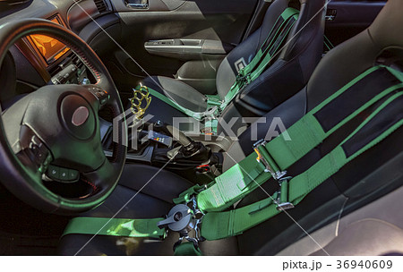 Automobile front seats with green seat belts and  36940609