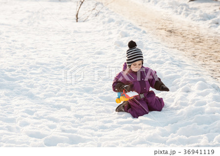 Kid plays on the snow Kid plays on the snow 36941119