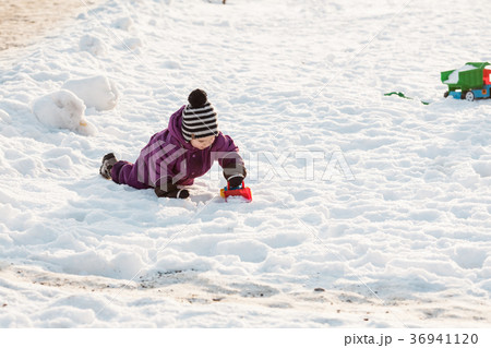 Kid plays on the snow Kid plays on the snow 36941120