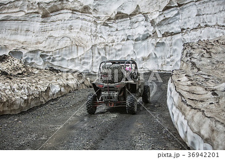 Buggy mountains driving on the road with snow 36942201