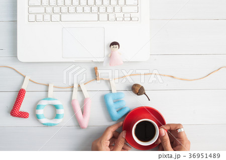 Woman hand holding coffee with love alphabets Woman hand holding coffee with love alphabets 36951489